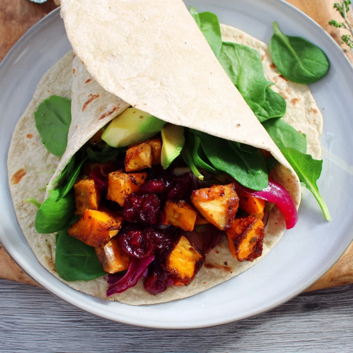 Loaded with colors and flavors, a delicious, perfectly rolled Roasted Sweet Potato & Black Bean Holiday Wrap.