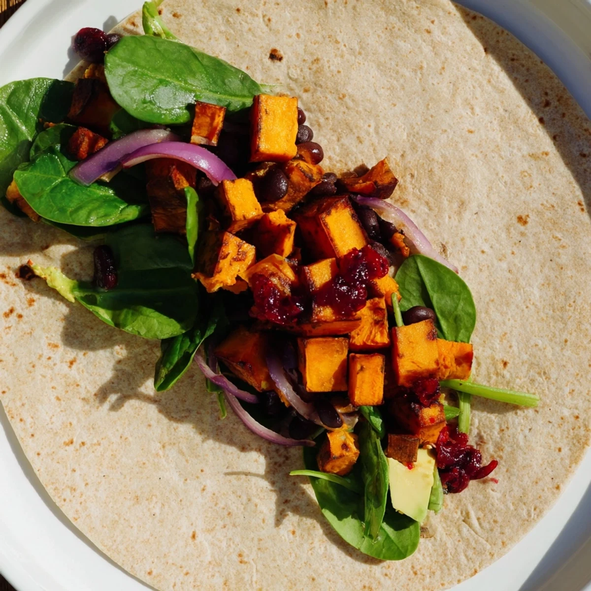 A warm, hearty Roasted Sweet Potato & Black Bean Holiday Wrap, ready for a delicious vegetarian meal.