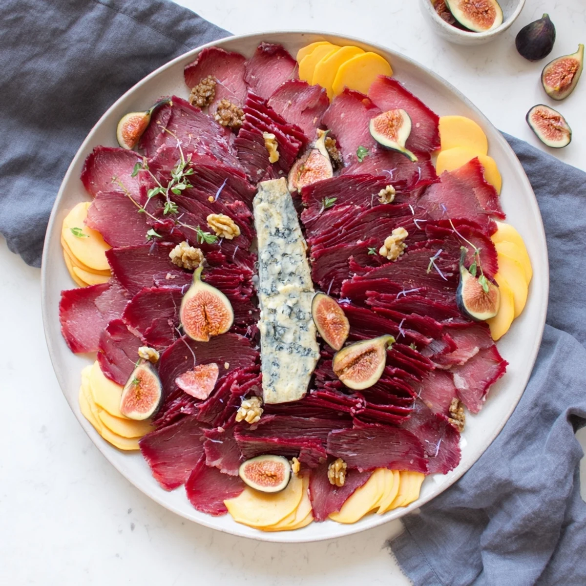 Close-up of a Majestic Venison Charcuterie Platter overflowing with artisan cheeses and cured meats.