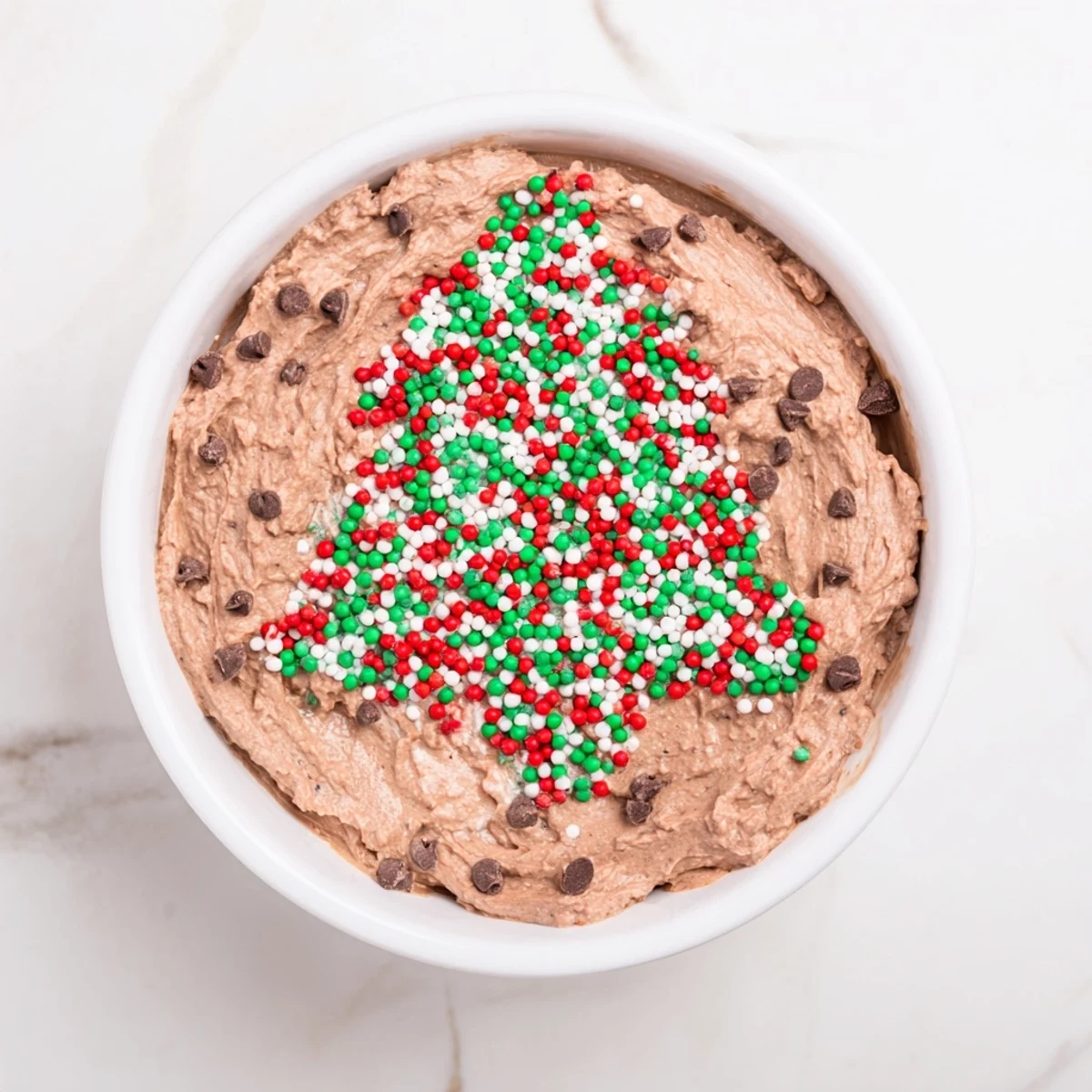 Creamy, rich Festive Tree Brownie Dip topped with festive sprinkles, perfect for holiday snacking.