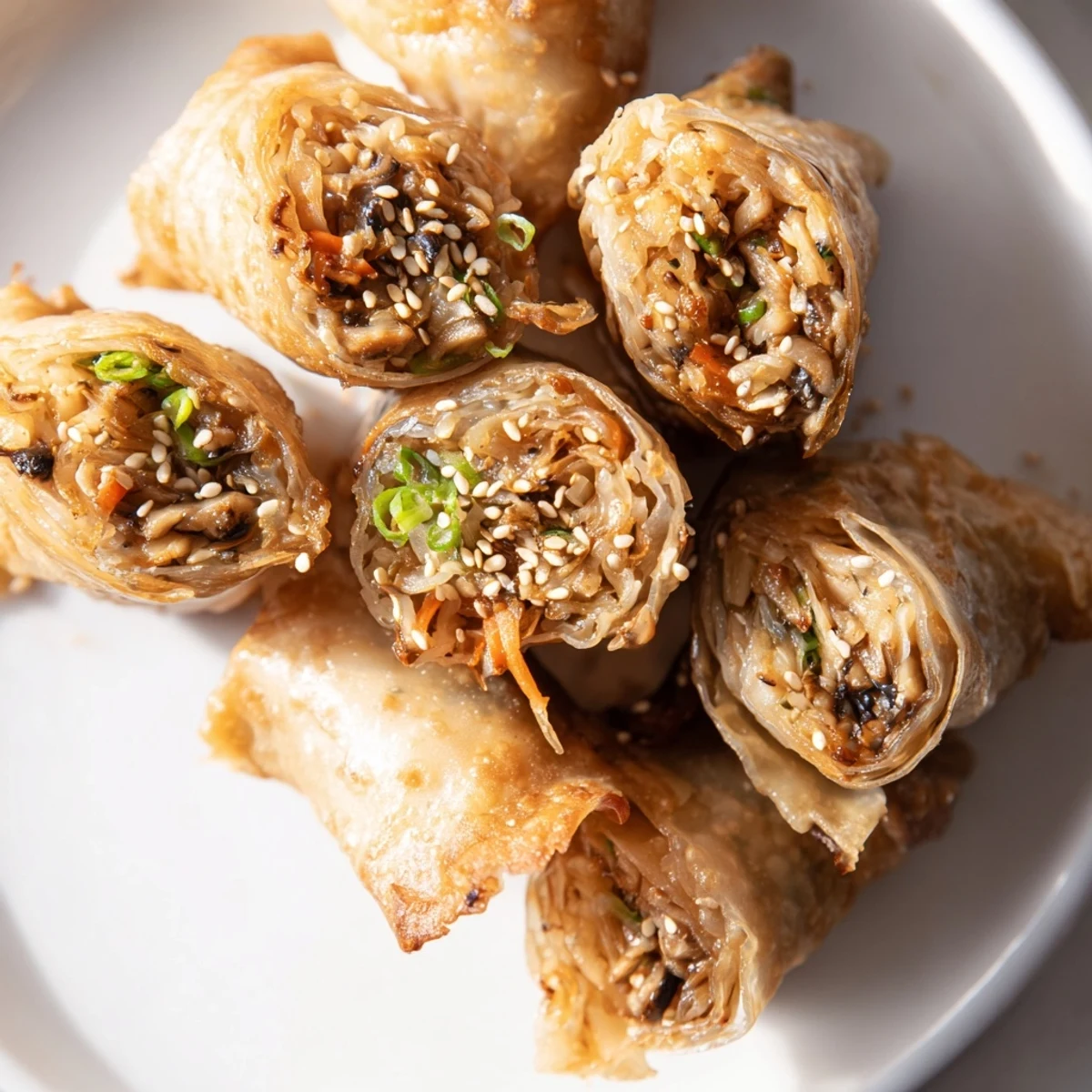 Golden, crispy rice paper dumplings presented on a plate, ready to be enjoyed with dipping sauce.