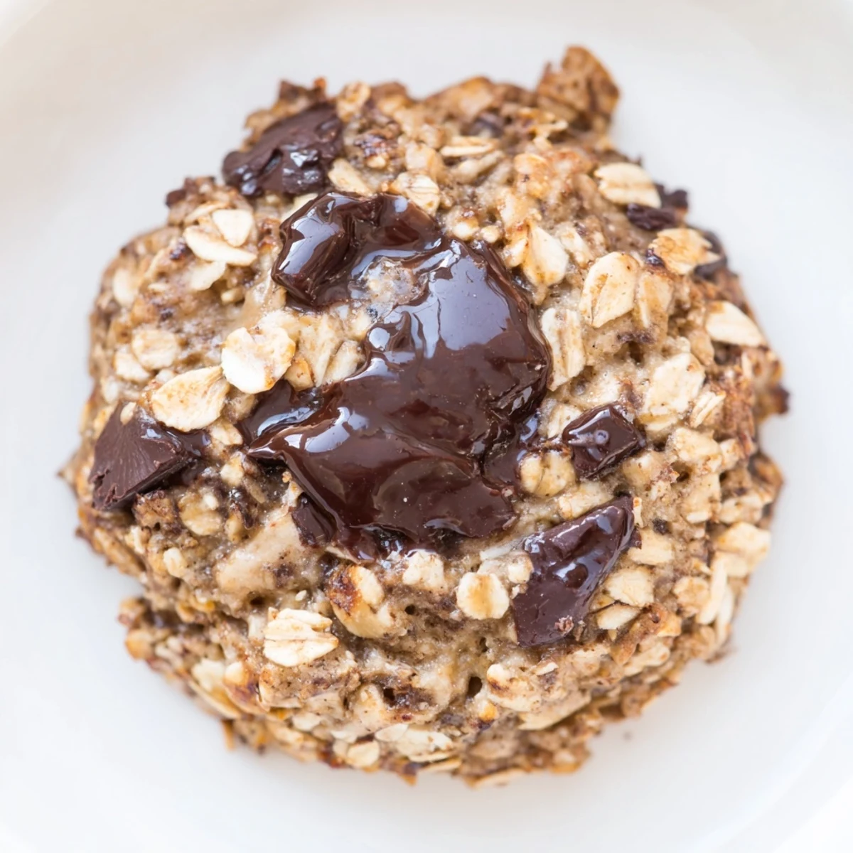 Golden-brown chocolate oatmeal breakfast cookies, perfect for mornings, overflowing with chocolate chips and inviting aroma.