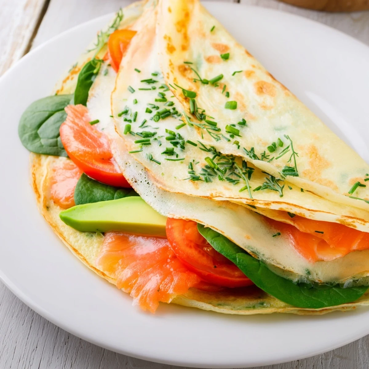 Deliciously thin blender-egg crepe wraps, folded to reveal fresh fillings, perfect for a quick and healthy breakfast.