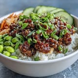 Sizzling gochujang beef with colorful vegetables and edamame in a hearty Korean ground beef bowl ready to enjoy.  