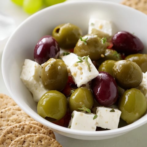 Cobblestone Courtyard appetizer: crackers and olives artfully arranged like a charming European street.
