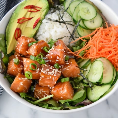 Fresh, colorful poke bowl salad with marinated fish, vibrant veggies, and crunchy toppings.