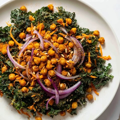 Crispy, golden roasted chickpeas top a fresh kale salad, a healthy and vibrant lunch or side.