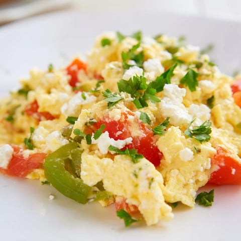 Delicious Turkish Menemen scramble, a colorful medley of tomatoes, peppers, and eggs, ready to eat.