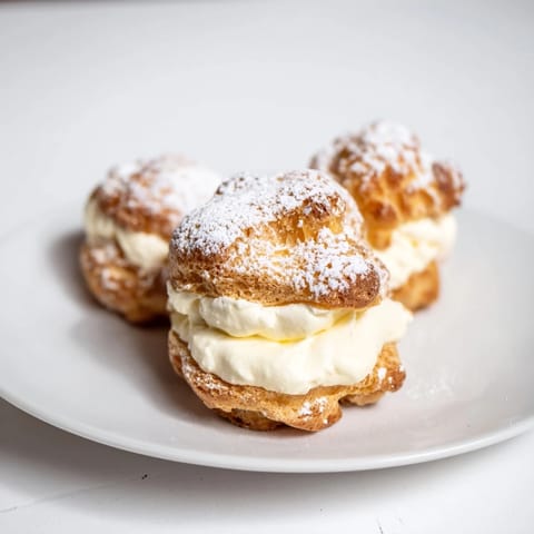 A close-up shot of homemade Chaos Karpatka showcasing its creamy vanilla filling, beckoning a bite.