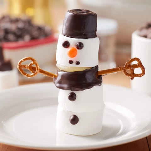 Kids will love these adorable Marshmallow Snowman Stick Arrangements, complete with pretzel arms and chocolate faces.