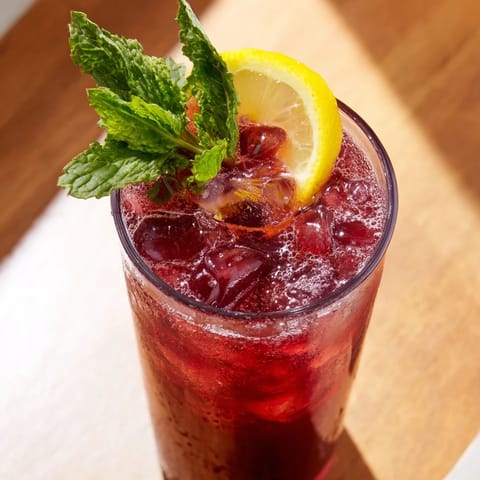 A close-up of a Sleepy Girl Cherry Mocktail garnished with lemon, perfect for a relaxing evening beverage.