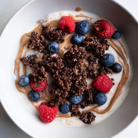 Creamy, layered gourmet overnight oats topped with crunchy granola and fresh seasonal berries.