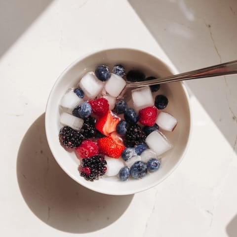 Nature's Cereal Bowl features fresh strawberries, blueberries, raspberries, and blackberries swimming in clear coconut water.  