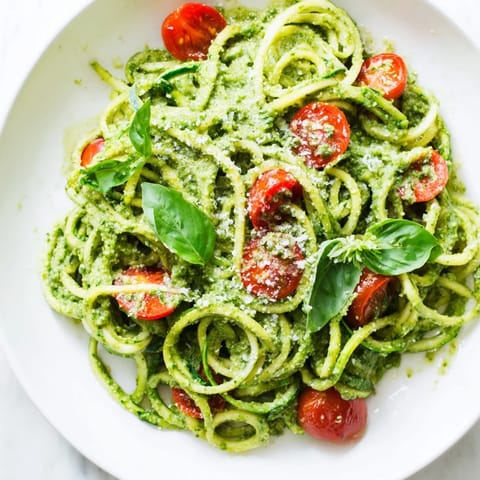 Sautéed zoodles mixed with homemade avocado pesto, served warm and garnished with fresh basil and Parmesan.
