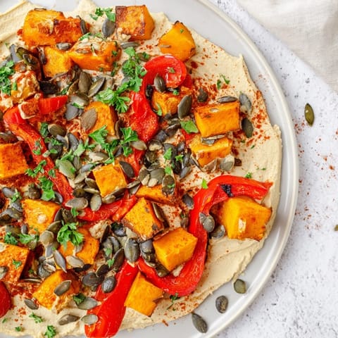 Golden roasted butternut squash and sweet potatoes piled high on creamy butter bean hummus, topped with toasted pumpkin and sunflower seeds.