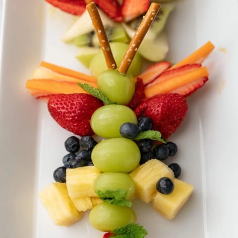 Butterfly Fruit Tray featuring colorful berries and melon, a perfect healthy snack.