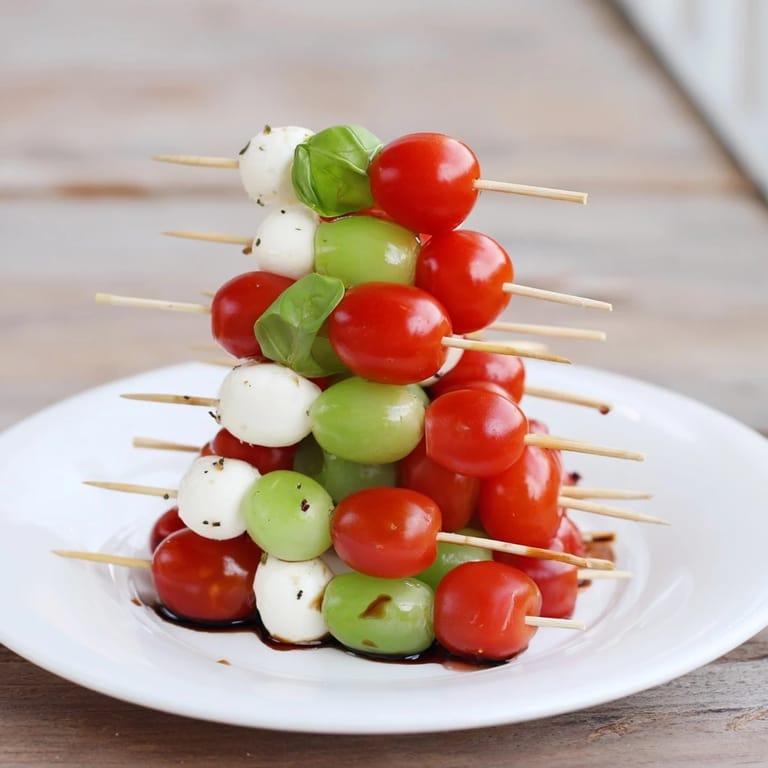 Vibrant red and green Caprese skewer tree, ready to serve, a vegetarian Italian appetizer favorite.