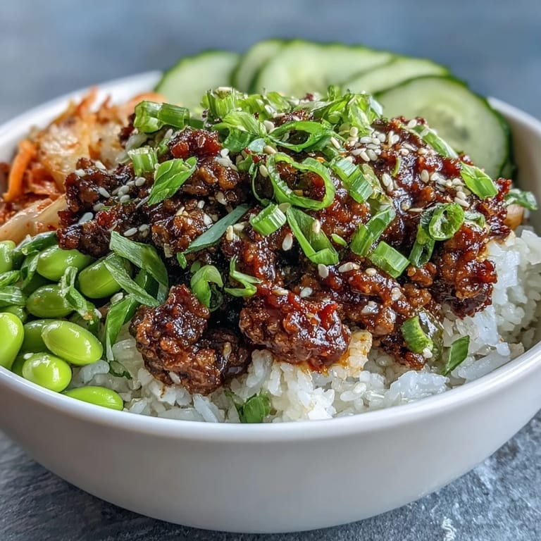 Sizzling gochujang beef with colorful vegetables and edamame in a hearty Korean ground beef bowl ready to enjoy.  