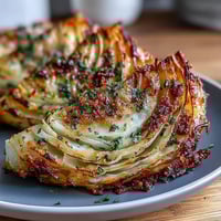 Golden Roasted Garlic Parmesan Cabbage Wedges are sizzling on a baking sheet with crispy edges.